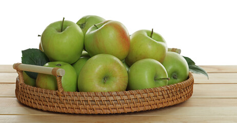 Fresh apples and green leaves on wooden table against white background