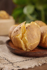 Hot Baked Potatoes with Fluffy Yellow Interior on Rustic Wooden Plate - Comfort Food Photography
