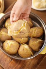 Hand Selecting Fresh Steamed Potato from Bowl - Gansu Style Cooking Preparation