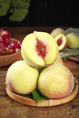 Fresh Sweet Peaches from Qingzhou Shandong China in Bamboo Basket on Wooden Table