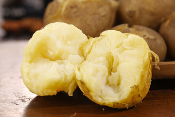 Fresh Gansu Sandyfaced Potatoes with Yellow Centers - Broken Open Showing Fluffy White Flesh for Cooking
