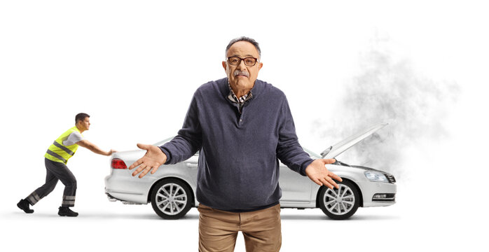 Sad mature man and road assistance worker pushing an inoperable vehicle
