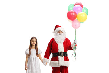 Santa claus with a bunch of balloons holding hands with a girl in a white dress
