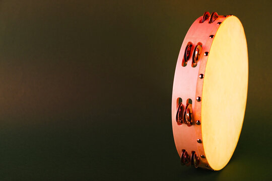 Tambourine on olive background. Space for text - Powered by Adobe