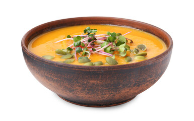 Delicious pumpkin soup with seeds and microgreens in bowl on white background
