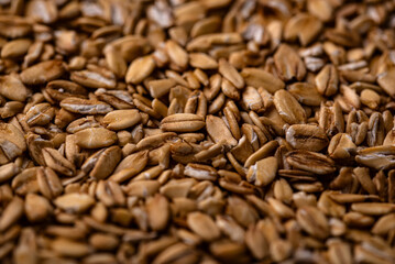 Textured brown flax seeds close-up background