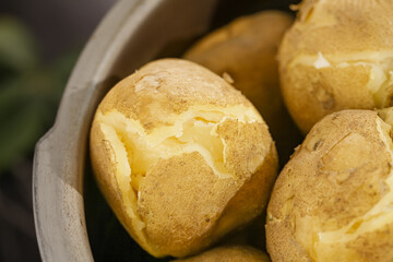 Fresh Cooked Golden Potatoes with Melting Butter in White Ceramic Bowl - Comfort Food from Gansu Origin