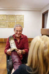 Man helping his wife put on boots in winter