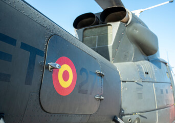 A military helicopter with the number 27 on the side. The red circle on the side of the plane is a symbol