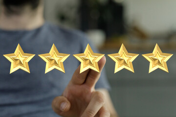 A person's finger pointing at five gold stars. Representing best service, product quality and...