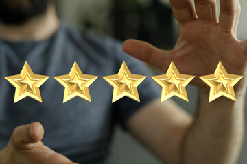 Person holding five golden stars representing customer satisfaction, positive feedback, or rating....