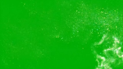Glittering particles on a green screen disappearing and appearing for visual effect transition footage