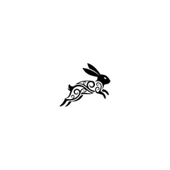 Black silhouette of a running rabbit with tribal, abstract ornate design on a white bg