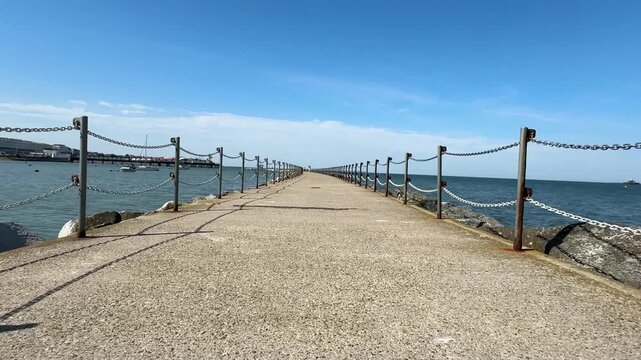 Cinematic 4K push-in shot filmed at 23.98 fps along the Herne Bay breakwater in Kent, England. 