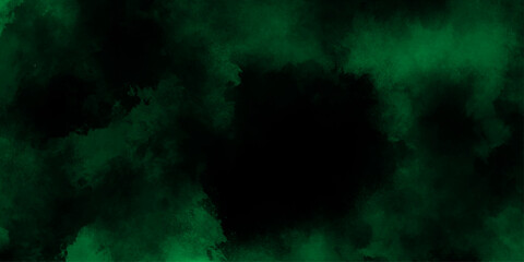 Abstract dark green or black  watercolor texture, dresembling a nebula or cosmic cloud formation, lime green smoke or fog on a black background, old vintage grunge design green Christmas background.