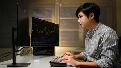 Busy business man trader broker analyst investor analyzing stock exchange trade crypto market using pc computer digital data investing finances in stock market working in dark office.