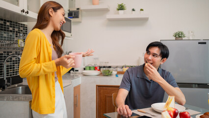 Asian adult couple happy morning breakfast kitchen discussion daily life domestic routine enjoy...