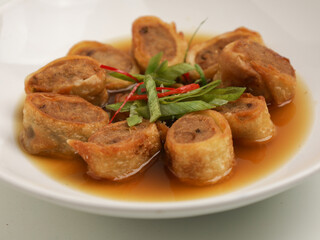 Gohyong or Ngohiong served with sweet and spicy sauce on white plate