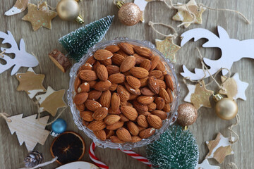 Various Christmas decorations, cookies, chocolate and nuts on wooden background. Flat lay.