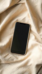 New Year Reset & Minimal Tech Lifestyle concept. A smartphone resting on a textured fabric surface, showcasing a sleek design and modern aesthetics.