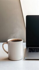 New Year Reset & Minimal Tech Lifestyle concept. Warm coffee mug beside a laptop on a minimalistic workspace, evoking productivity and comfort.