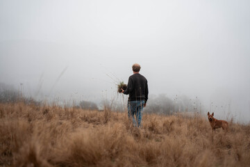 regenerative organic farmer, taking soil samples and looking at plant growth in a farm. practicing sustainable agriculture good looking farmer