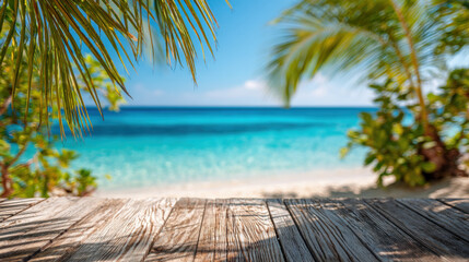 Bright sunny beach framed by lush palm leaves, wooden deck in foreground, crystal clear blue water