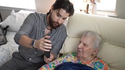 Grandson Shares Joyful Stories With Grandmother in Cozy Living Room Setting