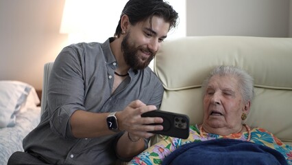 Grandson Shares Joyful Moments With Grandmother in a Cozy Living Room Setting
