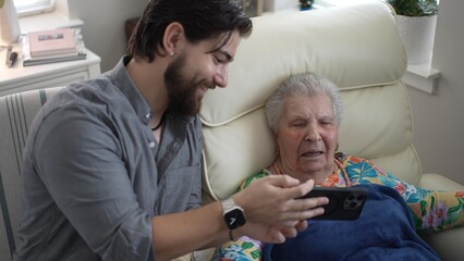 Grandson and Grandmother Share Joyful Memories Together in a Cozy Living Room