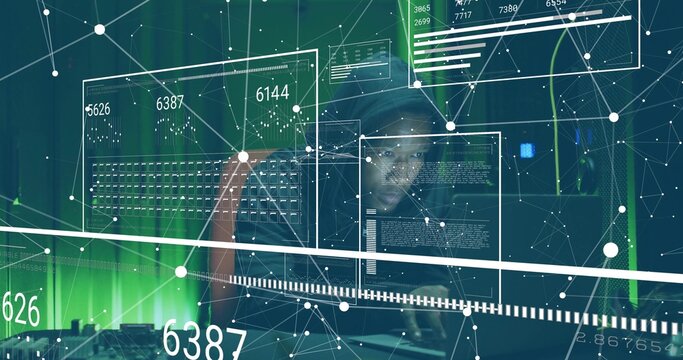 Monitoring adult IT specialist typing code at data center, with floating GUI, laptop, server racks