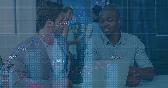 Collaborating business professionals analyzing laptop in office, with sticky board and data overlay