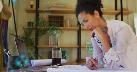 Working mature woman sketching renewable energy blueprints at design studio desk, copy space