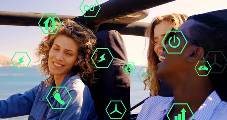 Driving three friends in convertible along coastal road, with green hexagon energy icons overlaying