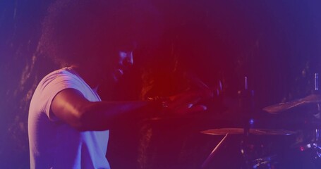 Playing Indian musician hitting snare and toms on stage with drumsticks and cymbals, copy space