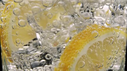 Refreshing lemonade with lemon slices splashing in a glass filled with sparkling water - Powered by Adobe