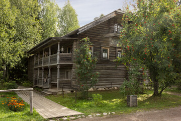 Ancient wooden house from the 19th century,  in a tourist complex in August in Mandrogi, Russia