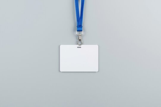 Blank identification card with blue lanyard on clean surface showcasing professional credentials