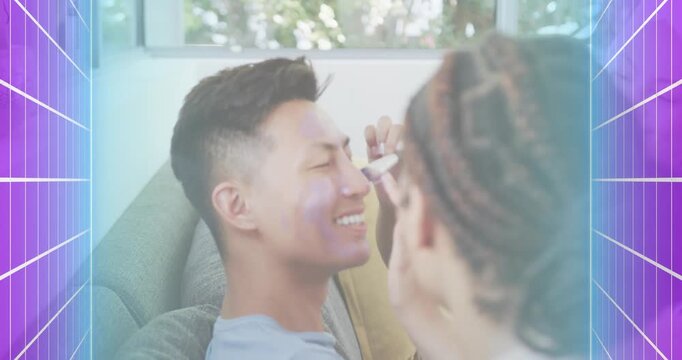 Man sitting on grey sofa receiving purple skincare cream from woman entering with gradient border