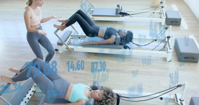 Instructor cueing Pilates clients pressing bars and pulsing bridge as floating data guiding core