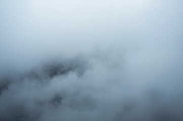 Ethereal mountain range shrouded in mist creates a sense of mystery and natural beauty