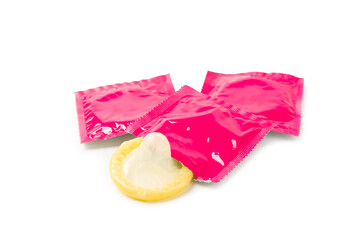Condoms isolated on white background. Colorful fruit-colored condoms in packaging. Safe sex concept. Contraceptive. Different birth control methods. Aids prevention. World AIDS Day. Sexual health.