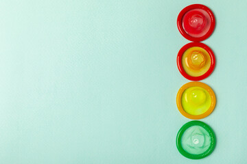 Condoms on a colored background. Colorful fruit-themed condoms in packaging. Safe sex concept....