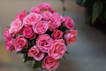 A vibrant bouquet of fresh pink roses is beautifully arranged, showcasing their delicate petals and soft hues.