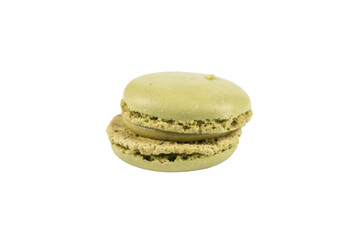 Single green macaron close-up. A green macaron shown close-up on white background. Its filling and cracked shell are visible. Macaron on a transparent background.