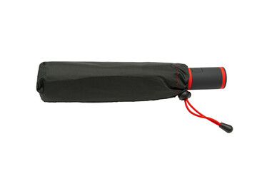 Black umbrella in sleeve. A compact black umbrella in a protective sleeve with a red strap. The handle features a push button. © Jakob