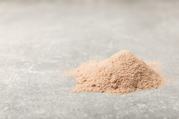 Protein powder. A spoonful of protein powder on a table. Different flavors of whey protein powder. Sports nutrition concept. Gym. Amino acid food supplement, creatine powder. Copy space.