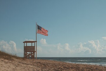 Sunny beach scene featuring lifeguard tower and American flag with beautiful ocean view