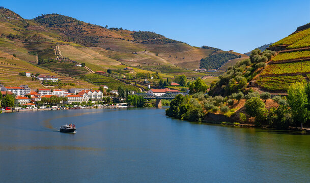 Scenic panorama of the landscape near Pinh&atilde;o in the Douro Valley in Portugal in late summer from a train. Boat tours and cruises along the vineyards and villages are very popular on the wide river.