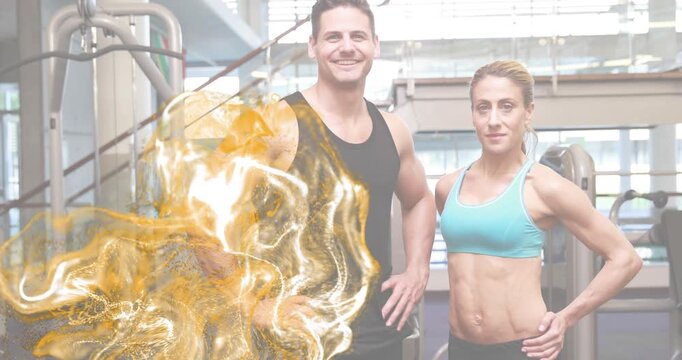Fitness duo standing in gym, golden swirl appearing corner and visualizing energy flow over trainer